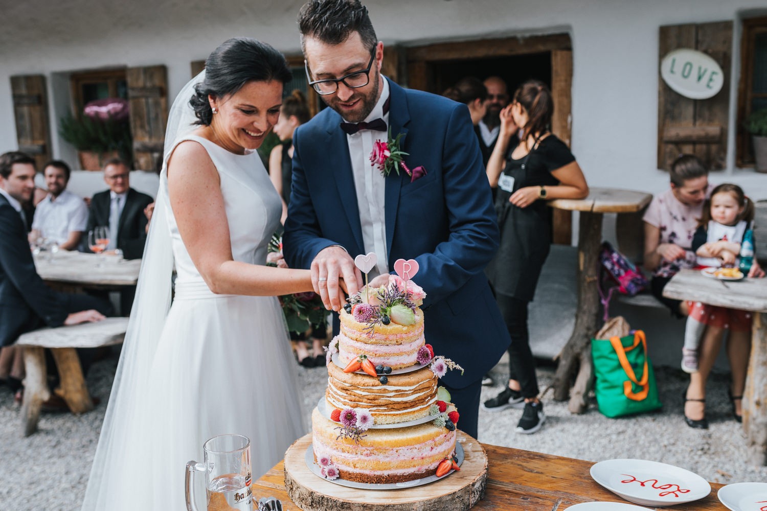freie Trauung auf Gut Aichet, das Brautpaar schneidet die Hochzeitstorte an